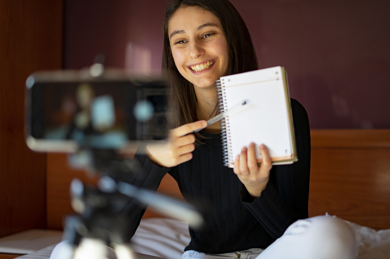young woman recording self on camera